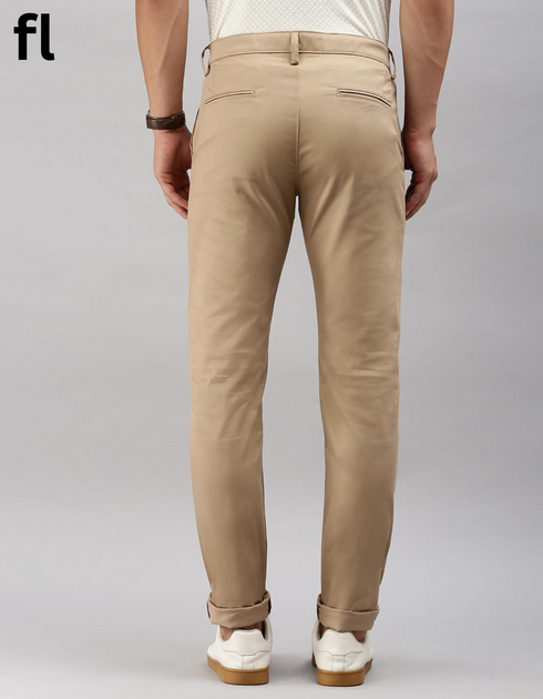 Beige pants worn by a person on a gray background