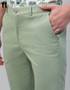 Light green pants worn by a person with a plain background