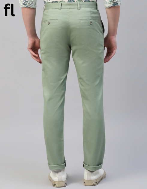 Green pants worn by a person on a plain background