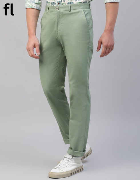 Light green pants worn by a person on a gray background